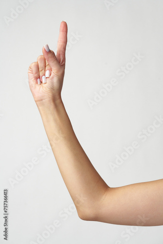 Female hand finger pointing on white background