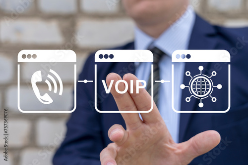 VOIP telecommunication concept. Business man using virtual touch screen presses abbreviation: VOIP. IP telephony and connection line web technology.