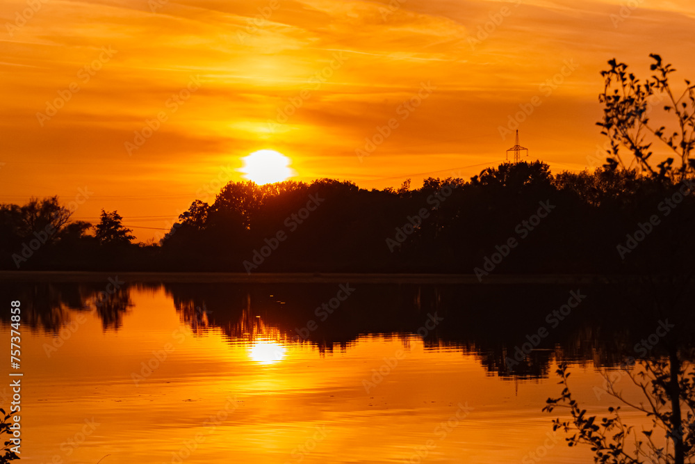 Summer sunset with reflections near Plattling, Isar, Bavaria, Germany