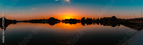 High resolution stitched summer sunset panorama with reflections near Plattling, Isar, Bavaria, Germany © Martin Erdniss