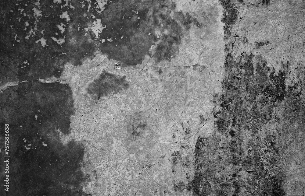 Fototapeta premium A weathered concrete wall with cracks and peeling paint, showing signs of age and decay.