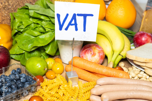 Food products and a sign with the inscription Vat (tax in Polish) Concept, Restoration of VAT on food in Poland. Increase in inflation and food prices