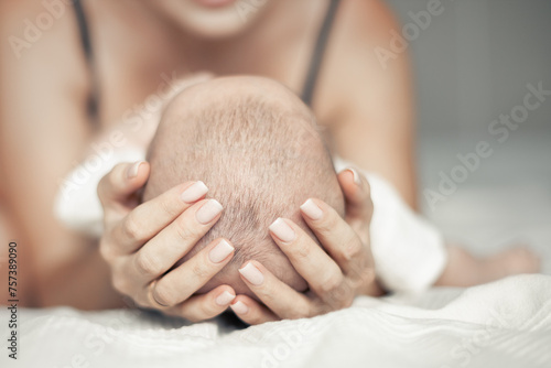 Tableau sur toile happy mother hugging her baby, maternal love and care, mother's day concept