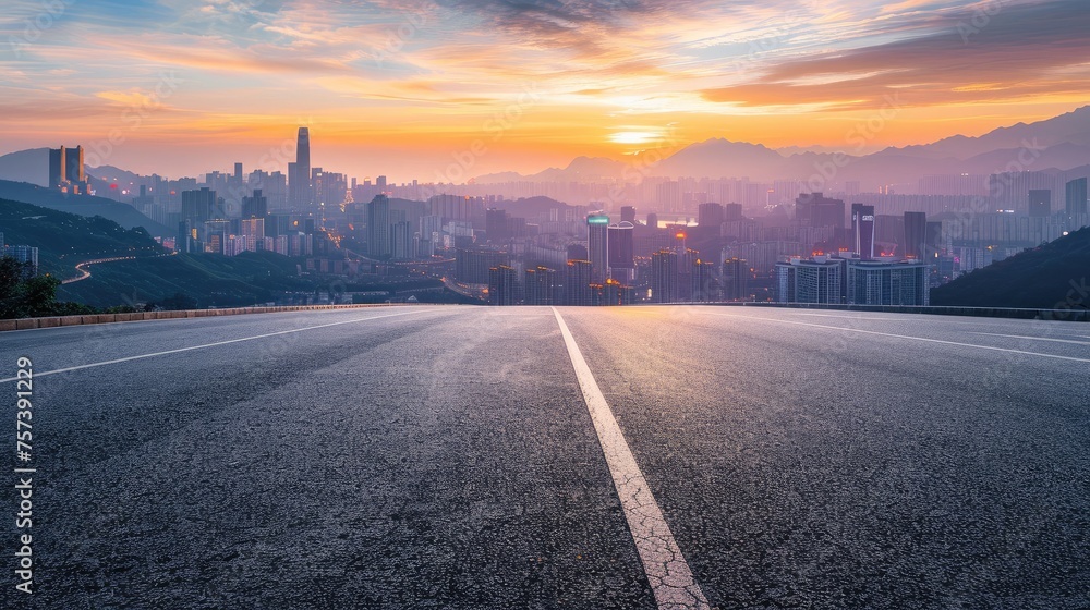 Asphalt highway road and mountains with city skyline at sunset Asphalt highway road and mountains with city skyline at sunset