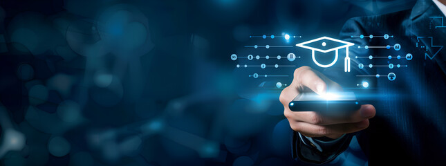 businessman wearing a suit is holding a finger over a hologram smartphone interface with a graduation hat icon on blue background, representing digital technology and online education