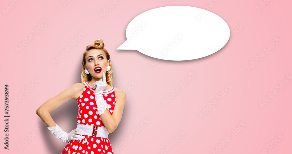 Studio portrait image - thinking pretty woman wear red pin up dress. Blond pinup thougthfull girl. White empty blank mockup speech sign bubble cloud having idea. Isolated against pink wall background. Studio portrait image - thinking pretty woman wear red pin up dress. Blond pinup thougthfull girl. White empty blank mockup speech sign bubble cloud having idea. Isolated against pink wall background.
