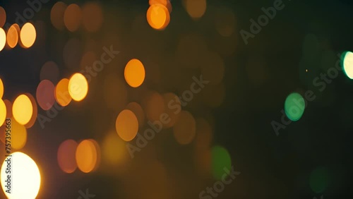 Bright colorful abstract bokeh circles moving around. Green,orange and red design. Abstract colorful pattern with defocused lights on black background with space for your text. contains transparencies photo