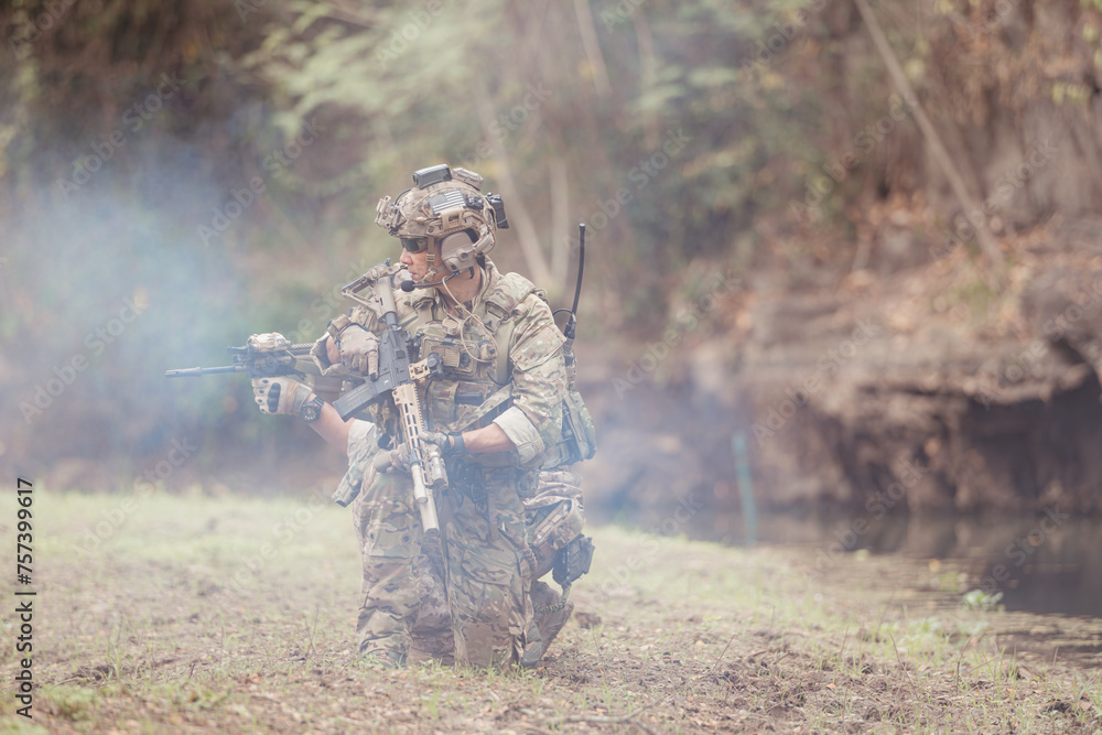 Soldiers in camouflage military uniforms carrying weapons, Reconnaissance missions in the tropical forest area, Assault infantry battle training. Soldiers in camouflage military uniforms carrying weapons, Reconnaissance missions in the tropical forest area, Assault infantry battle training.