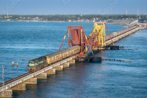 Indian Railways passenger train crossing historical , 2 kms long Pamban sea bridge. photo