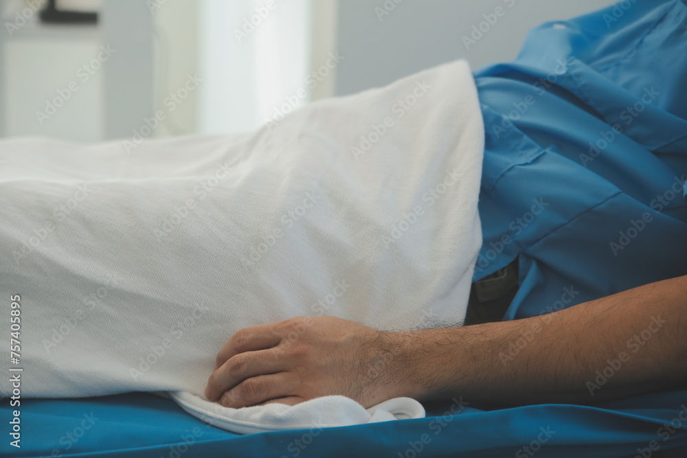 Seriously Ill Man Lying on a Bed in the Hospital. Monitors Show His Vital Signs. Ward is Clean and New. Seriously Ill Man Lying on a Bed in the Hospital. Monitors Show His Vital Signs. Ward is Clean and New.