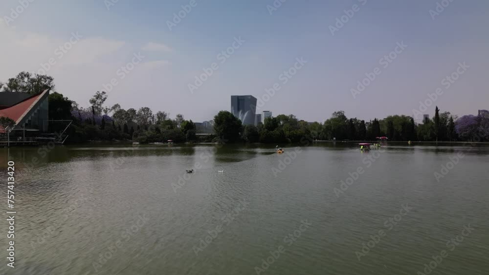 Drone view of lake surrounded by trees at Chapultepec park in Mexico City on a sunny day Drone view of lake surrounded by trees at Chapultepec park in Mexico City on a sunny day