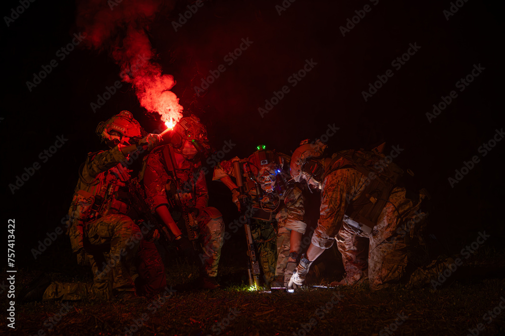 Group of soldiers in camouflage uniforms hold weapons with patrol missions at night Group of soldiers in camouflage uniforms hold weapons with patrol missions at night