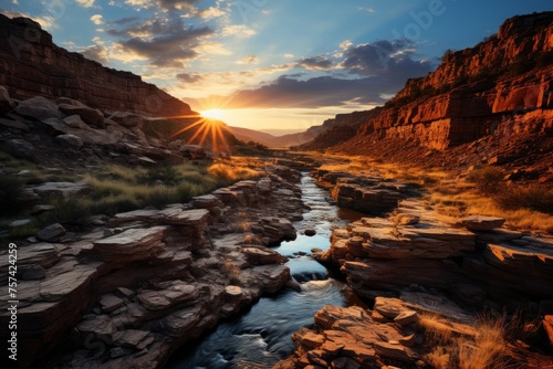 The sun sets over a canyon river, painting the sky with vibrant colors