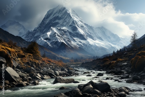 Majestic river flows through snowy mountain valley with clouddotted sky