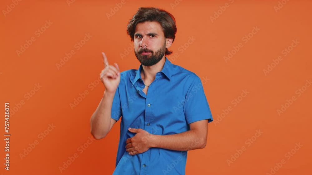 Face palm. Shame on you. Upset middle eastern young man making face palm gesture, feeling bored, disappointed in result, bad news, sorrowful. Unhappy guy isolated on orange studio background indoors