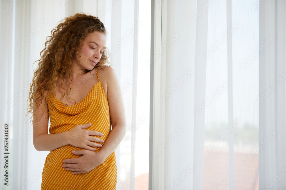 pregnant woman smiling and relaxing in the bedroom pregnant woman smiling and relaxing in the bedroom