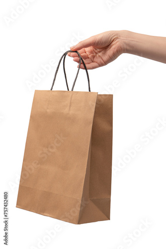 Paper bag in woman hand isolated on a white background.