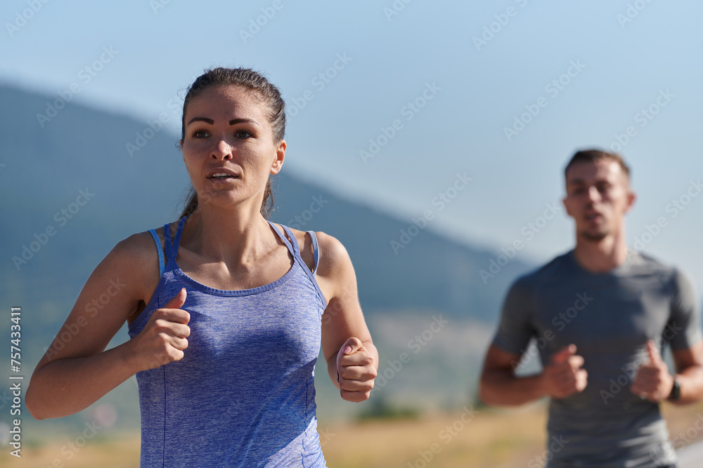 Energized by the beauty of nature, a couple powers through their morning run, their bodies and spirits invigorated. Energized by the beauty of nature, a couple powers through their morning run, their bodies and spirits invigorated.