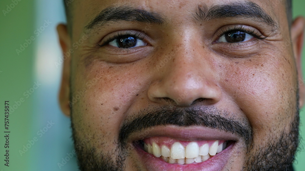 Macro close-up portrait of a hispanic black latin man smiling at camera. Tight closeup of South American person in 20s wide grin Macro close-up portrait of a hispanic black latin man smiling at camera. Tight closeup of South American person in 20s wide grin