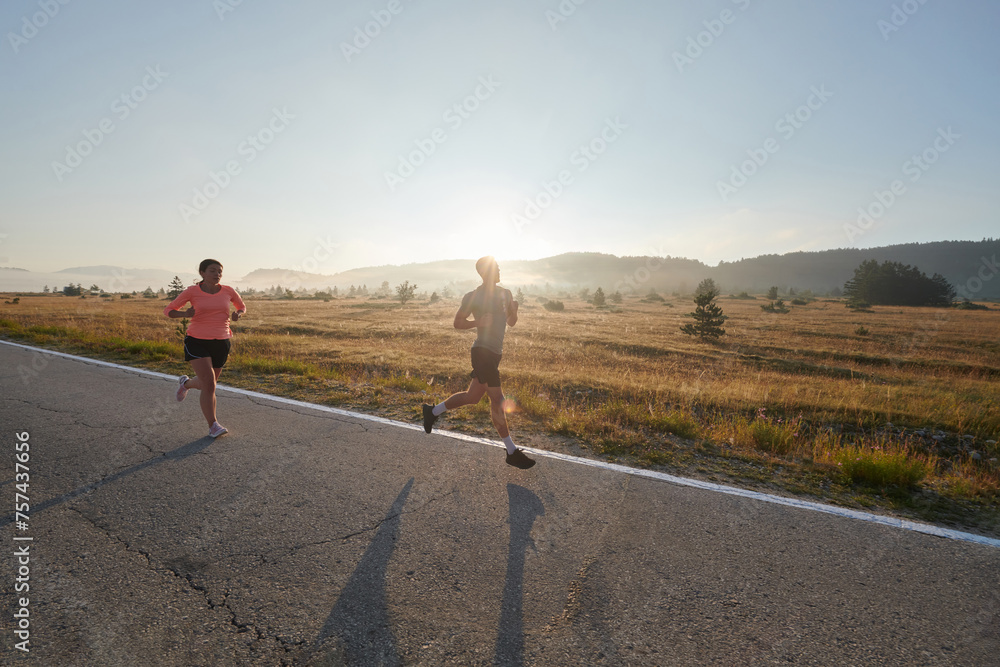 Obraz premium Energized by the beauty of nature, a couple powers through their morning run, their bodies and spirits invigorated.