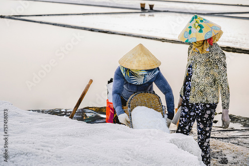 Women are harvesting salt in Can Gio, a suburb of Ho Chi Minh City, Vietnam.