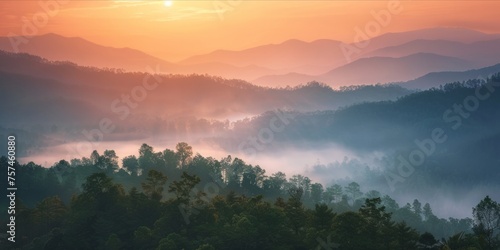 Sunrise over a misty mountain forest.
