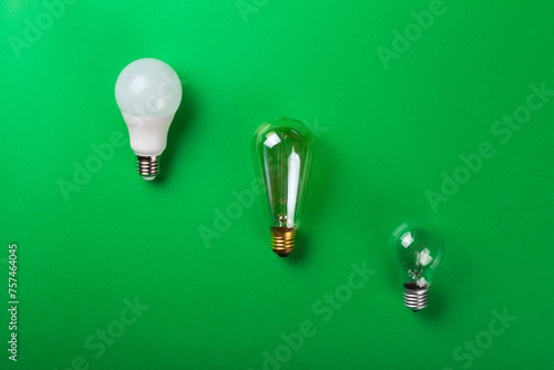 Led lamp or incandescent lamp, edison lanp on isolated green background. Flat lay. Concept ecology, save planet earth, idea, save energy, economy, saving. Earth day. Smart shopping, sale, buy. photo