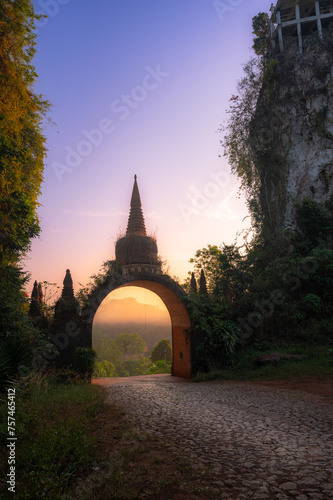 Temple gate (Phutthawadee arch) of Khao Na Nai Luang Dharma Park at sunrise, Surat Thani, Thailand photo