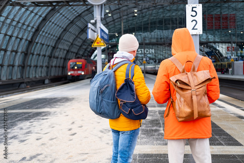 two men in orange jackets at station, Passengers with backpacks wait train, Berlin Hauptbahnhof, concept boarding travelers in cars, hustle and bustle train travel, Berlin, Germany