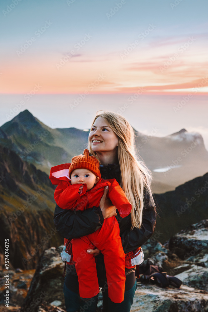 Mother walking with infant baby in mountains outdoor family travel lifestyle scandinavian woman with child hiking in Norway summer vacations in Lofoten islands Mothers day holiday - obrazy, fototapety, plakaty 