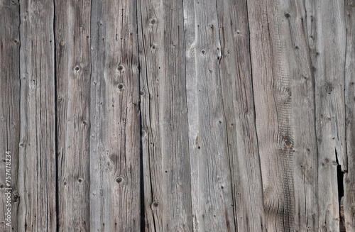 Texture of old weathered unpainted wooden plank fence