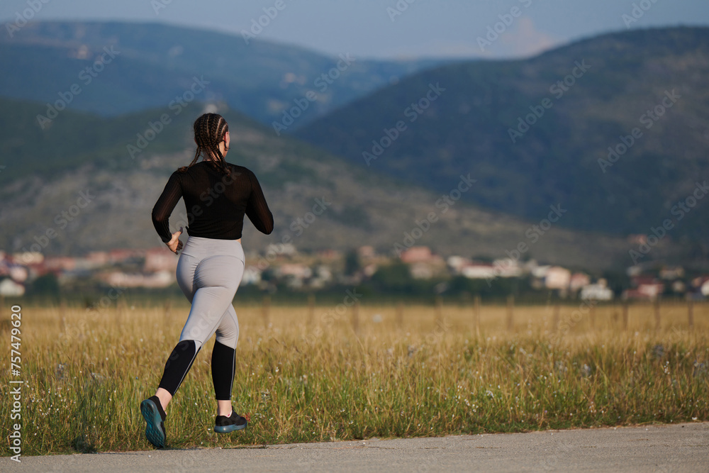 A determined woman athlete trains for success in the morning sun. A determined woman athlete trains for success in the morning sun.