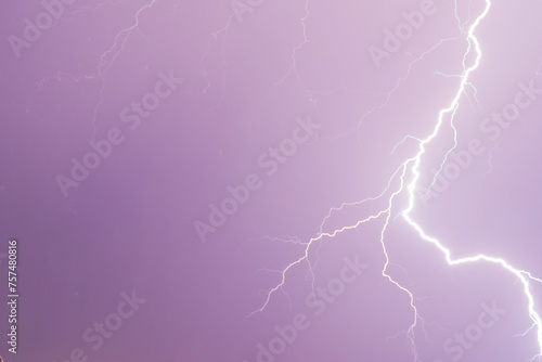 Dark stormy sky with bright flash of lightning strikes during thunderstorm at night. Dramatic and nature concept