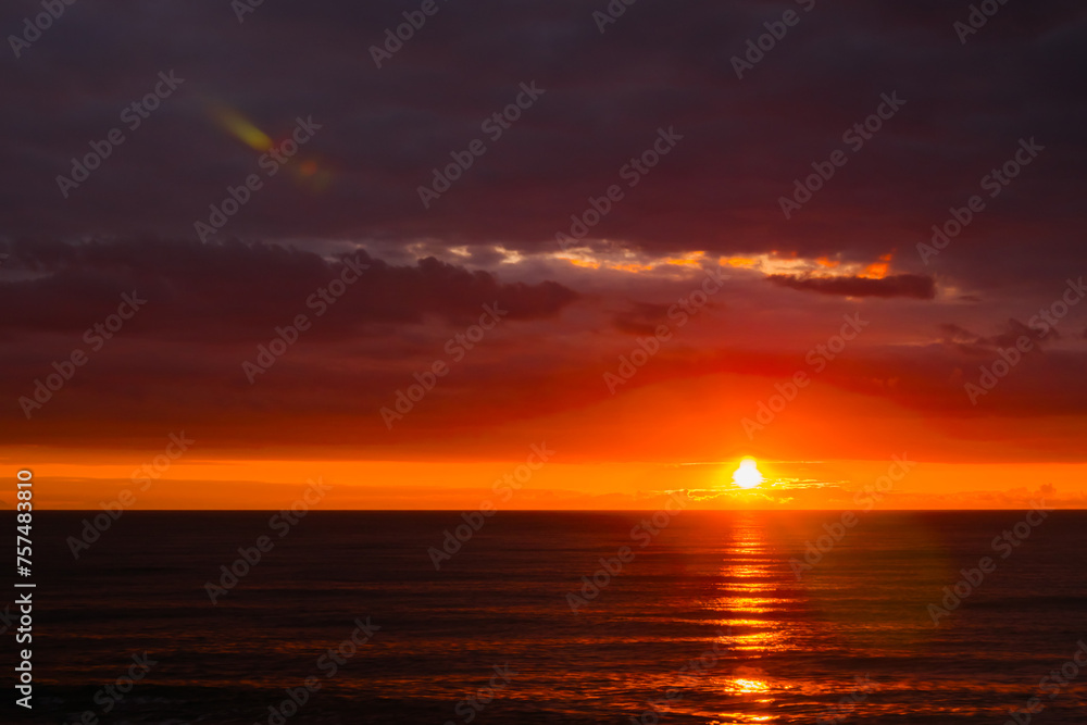 Amazing dramatic sunset sky with clouds over the Black Sea surface in the evening. Summer, cloudscape and nature concept
