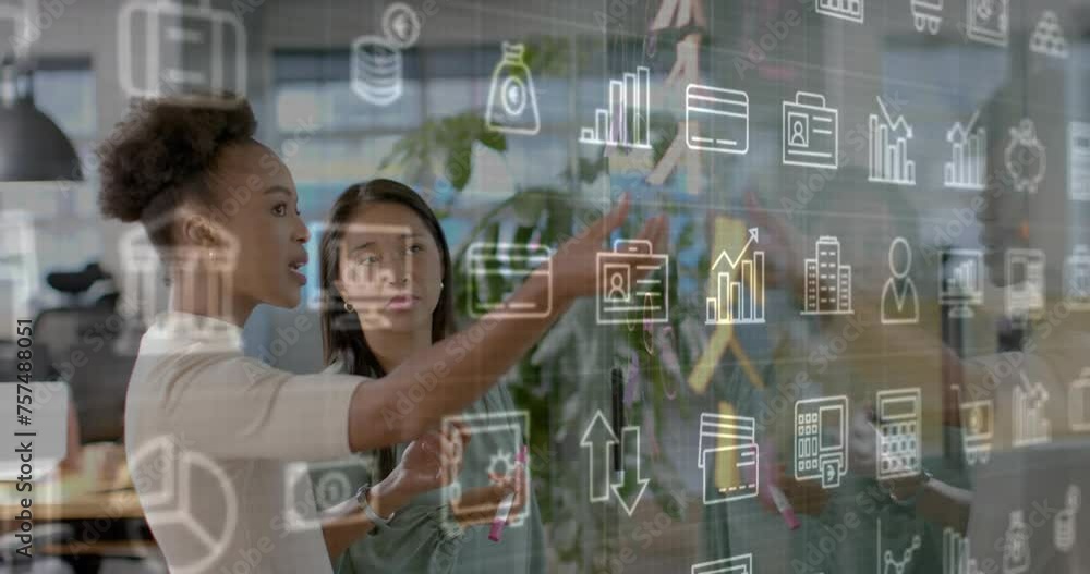 Animation of business media logos over diverse female colleagues brainstorming at casual office Animation of business media logos over diverse female colleagues brainstorming at casual office