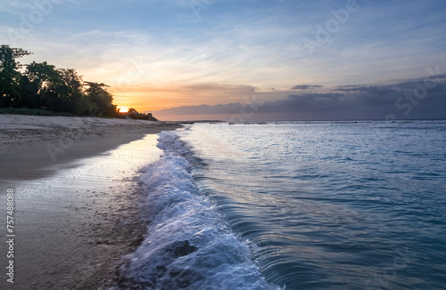 Sunrise on the famous Pacific Ocean. Beautiful summer sea view. Amazing sunrise. Morning landscape. Waves with foam. Romantic vacation spots Bali island Indonesia photo