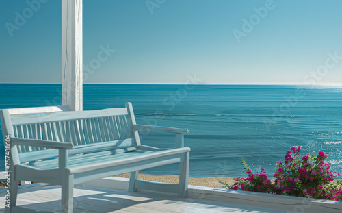 A blue bench is on a wooden deck overlooking the ocean © IonelV
