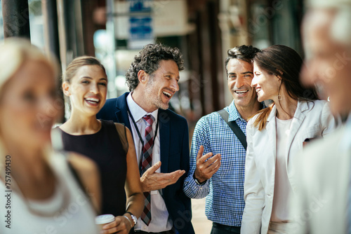 Diverse business people laughing while walking to work photo