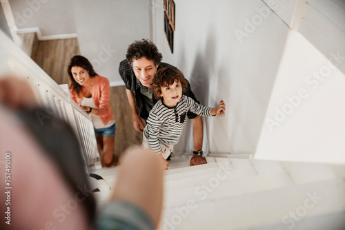 Family playing on stairs at home photo