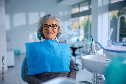 Happy senior woman having appointment at the dentist. photo