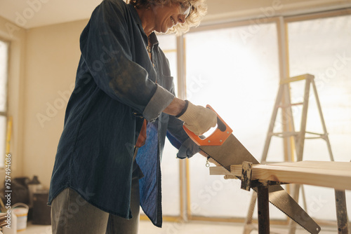 Renovation in the making: Skilled woman upgrades home interior with custom woodwork photo