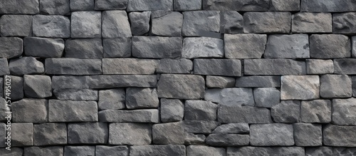 A detailed closeup of a gray brick wall showcasing the intricate patterns and textures of the rectangular building material