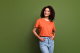 Photo of charming cute woman wear orange t-shirt smiling empty space isolated green color background