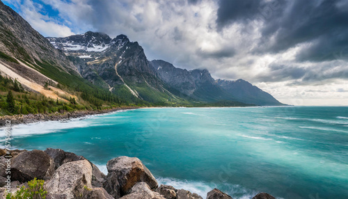 Rocky mountain in the water. Blue ocean. Cliff coast. Beautiful seascape. Dramatic gray blue sky.