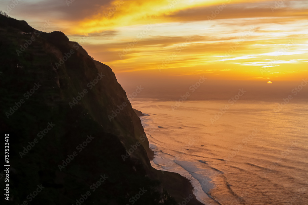 Watching breathtaking sunset at viewing point Miradouro do Ponta da Ladeira, Madeira island, Portugal, Europe. Panoramic view of majestic coastline of Atlantic Ocean. Peaceful tranquil atmosphere. Awe