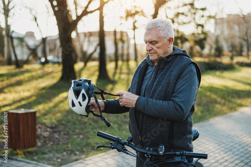 Older Man Holding Helmet on Bike