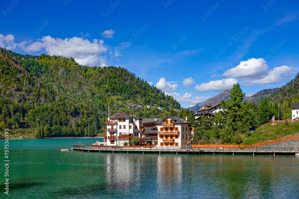 Touristic view of Alleghe resort in the italian Dolomites on bright autumn day, Europe