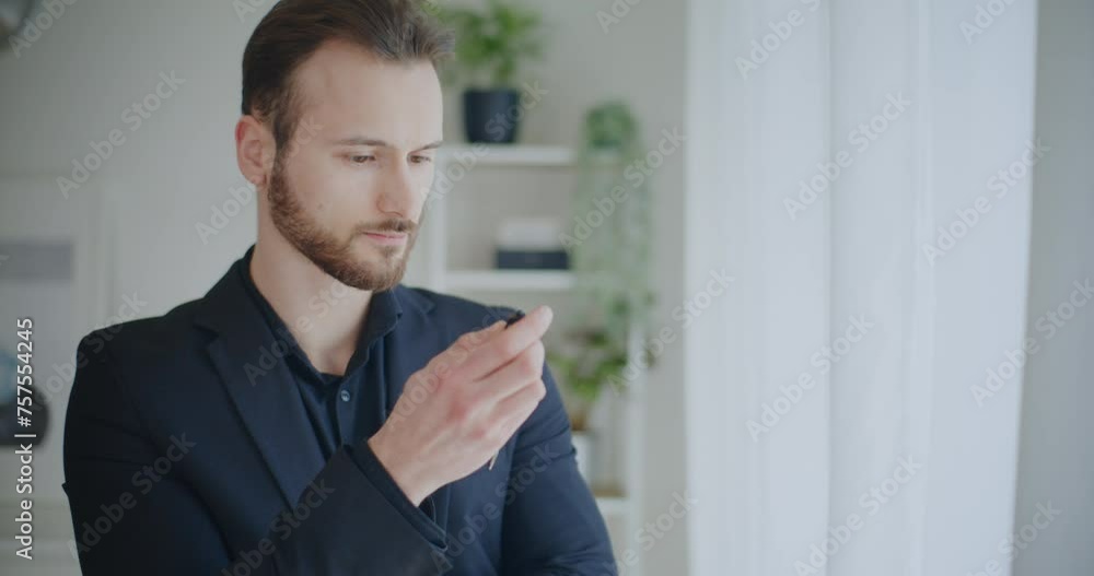 Handsome businessman holding pen brainstorming strategy Handsome businessman holding pen brainstorming strategy