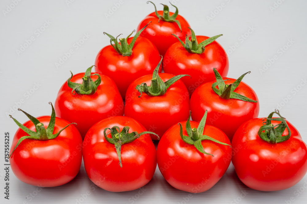 Food triangle, Red ripe tasty Dutch tomatoes, vegetables background top view close up copy space