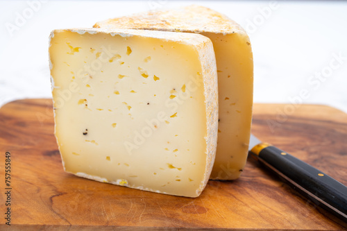 Piece of Ciambella Trufilo cheese made with summer truffel from Piedmontese cow milk in Langa area, Italy photo